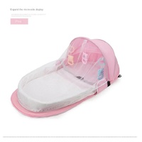 Pink Portable Multi-Purpose Baby Bed and Diaper Backpack - Lightweight, Waterproof, Canvas + Polyester Material, Travel Essential for Moms(With mosqui thumbnail